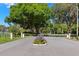 The entrance to Lansbrook Residents and Parkhouse set behind lush foliage and secure barriers at 4564 Juniper Dr, Palm Harbor, FL 34685