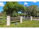 Lansbrook Lakefront Park entrance featuring a black and gold sign, neatly kept lawns, and mature trees at 4564 Juniper Dr, Palm Harbor, FL 34685