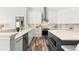 Well-lit kitchen featuring an island, stainless steel appliances, and modern cabinetry and wood-look flooring at 4564 Juniper Dr, Palm Harbor, FL 34685