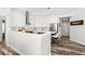 Contemporary kitchen with white cabinets, stainless steel appliances, and bar seating at 4564 Juniper Dr, Palm Harbor, FL 34685