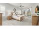 A bright and airy bedroom with neutral tones, wood furnishings, and french door access to the pool at 4564 Juniper Dr, Palm Harbor, FL 34685