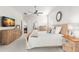 Spacious main bedroom featuring a wooden sleigh bed, neutral decor, and ample natural light at 4564 Juniper Dr, Palm Harbor, FL 34685
