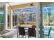 A view from inside of the screened patio with a table and chairs at 4564 Juniper Dr, Palm Harbor, FL 34685