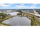 Aerial view of a lakeside community with mature trees, highways, and views of the greater metropolitan area at 4647 Lake Villa Dr, Clearwater, FL 33762