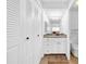 Hallway view of bathroom with a large vanity and closet space at 4647 Lake Villa Dr, Clearwater, FL 33762
