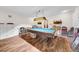 Billiards room with vintage style light, shelving, and wood floors offers a fun community recreation space at 4647 Lake Villa Dr, Clearwater, FL 33762