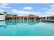 Large community pool with clear blue water, tiki umbrellas, and lounge chairs offers a relaxing outdoor space at 4647 Lake Villa Dr, Clearwater, FL 33762