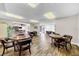Community room with multiple tables, and wood floors offers an inviting space for community gatherings and activities at 4647 Lake Villa Dr, Clearwater, FL 33762