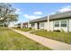 Inviting single-story townhomes feature lush front lawns and sidewalks leading to each residence at 4647 Lake Villa Dr, Clearwater, FL 33762