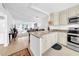 Open-concept kitchen featuring granite countertops and views into the living area at 4647 Lake Villa Dr, Clearwater, FL 33762