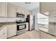 Bright kitchen featuring stainless steel appliances, granite countertops, and neutral cabinetry at 4647 Lake Villa Dr, Clearwater, FL 33762