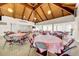Spacious meeting room with wood vaulted ceilings and round tables offers a flexible community gathering space at 4647 Lake Villa Dr, Clearwater, FL 33762