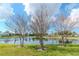 Peaceful pond surrounded by trees and grass, with a clear reflection of the sky at 4816 Snook Se Dr # A, St Petersburg, FL 33705