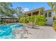 Gorgeous backyard features a pool, covered patio, and ample seating, creating a perfect outdoor oasis at 5010 W Dickens Ave, Tampa, FL 33629