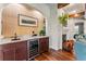 Custom bar area with a wine fridge, sink, and beautiful granite countertops is perfect for entertaining at 5010 W Dickens Ave, Tampa, FL 33629