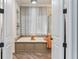 Relaxing bathroom with a soaking tub, neutral palette, and tiled flooring at 5010 W Dickens Ave, Tampa, FL 33629