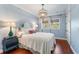 Bedroom featuring a decorative chandelier, hardwood floors and bright natural light at 5010 W Dickens Ave, Tampa, FL 33629