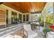 A lovely patio space with wood ceilings, outdoor dining, and comfortable seating for relaxing at 5010 W Dickens Ave, Tampa, FL 33629
