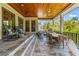 Charming covered patio with wood ceiling, ceiling fan and ample outdoor seating for relaxing and dining at 5010 W Dickens Ave, Tampa, FL 33629