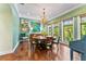 Dining room featuring a round wood table, unique wall decor, and three windows at 5010 W Dickens Ave, Tampa, FL 33629