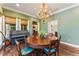 Dining room featuring a round table, a piano, and an arched entryway into the living room at 5010 W Dickens Ave, Tampa, FL 33629