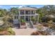 Stately two-story home with a metal roof, brick driveway, and well-manicured landscaping at 5010 W Dickens Ave, Tampa, FL 33629