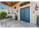 Charming covered entry with double front doors, a swing, and stylish outdoor decor at 5010 W Dickens Ave, Tampa, FL 33629