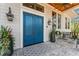 Covered front entrance with double doors, wood ceiling, stylish lanterns, and outdoor seating at 5010 W Dickens Ave, Tampa, FL 33629