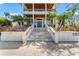 Elegant front entrance with a large staircase leading to the double front doors and balcony above at 5010 W Dickens Ave, Tampa, FL 33629