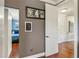 Hallway featuring hardwood floors, white doors, and hallway decor at 5010 W Dickens Ave, Tampa, FL 33629