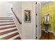 Hallway with a staircase and an entrance into the half-bathroom featuring a unique vanity at 5010 W Dickens Ave, Tampa, FL 33629