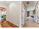 Hallway view showcasing hardwood floors and access to a living area with neutral colored furniture at 5010 W Dickens Ave, Tampa, FL 33629