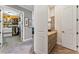 Hallway view of bathroom vanity and walk-in closet with custom shelving and built-in organizers at 5010 W Dickens Ave, Tampa, FL 33629