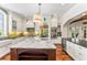 Bright kitchen with large island, white cabinetry, stone backsplash, and stainless steel appliances at 5010 W Dickens Ave, Tampa, FL 33629