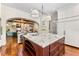 Kitchen featuring a marble island with cabinets, a wine cooler, and an open view into the living room at 5010 W Dickens Ave, Tampa, FL 33629