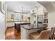 Gourmet kitchen with white cabinets, stainless appliances, and a large central island at 5010 W Dickens Ave, Tampa, FL 33629