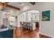 Open-concept living room with hardwood floors leads to the kitchen and dining area at 5010 W Dickens Ave, Tampa, FL 33629