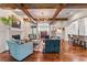 Beautiful living room featuring beamed ceilings, fireplace, and an open floor plan at 5010 W Dickens Ave, Tampa, FL 33629