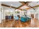 Spacious living room showcasing a stone fireplace, beamed ceiling, and adjacent bar area at 5010 W Dickens Ave, Tampa, FL 33629
