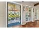 Indoor entryway into the outdoor patio featuring flagstone pavers, ceiling fans, and an outdoor dining area at 5010 W Dickens Ave, Tampa, FL 33629