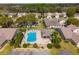 Overhead view of a community pool area, surrounded by manicured landscaping and comfortable lounge chairs at 6428 Thicket Trl, New Port Richey, FL 34653