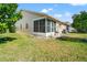 Home exterior showcasing a well-maintained lawn and a screened lanai, perfect for enjoying the outdoors at 6428 Thicket Trl, New Port Richey, FL 34653