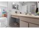Open bathroom with a large vanity, ample lighting, and a view into the bedroom at 6428 Thicket Trl, New Port Richey, FL 34653