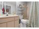 Bathroom features a bathtub and shower with a large vanity and sink at 6428 Thicket Trl, New Port Richey, FL 34653