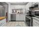 Well-lit kitchen featuring white cabinets and stainless steel appliances at 6428 Thicket Trl, New Port Richey, FL 34653