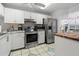 Bright kitchen with stainless steel appliances, white cabinets, and ample counter space for cooking at 6428 Thicket Trl, New Port Richey, FL 34653