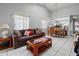 Cozy living room with open floorplan featuring large windows and dining area at 6428 Thicket Trl, New Port Richey, FL 34653