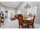 Bright living room with white tile flooring and a dining area, perfect for entertaining at 6428 Thicket Trl, New Port Richey, FL 34653