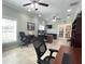 Bright office area with a ceiling fan, large desk and multiple windows at 7203 Spring Valley Dr, Tampa, FL 33615