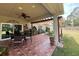 Tiled patio with ceiling fan, table and chairs that opens onto the yard at 7203 Spring Valley Dr, Tampa, FL 33615